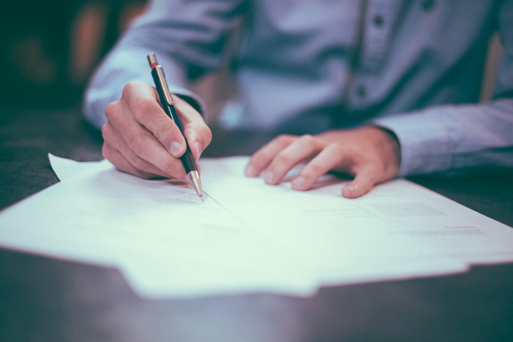Chiropractor signing insurance paperwork